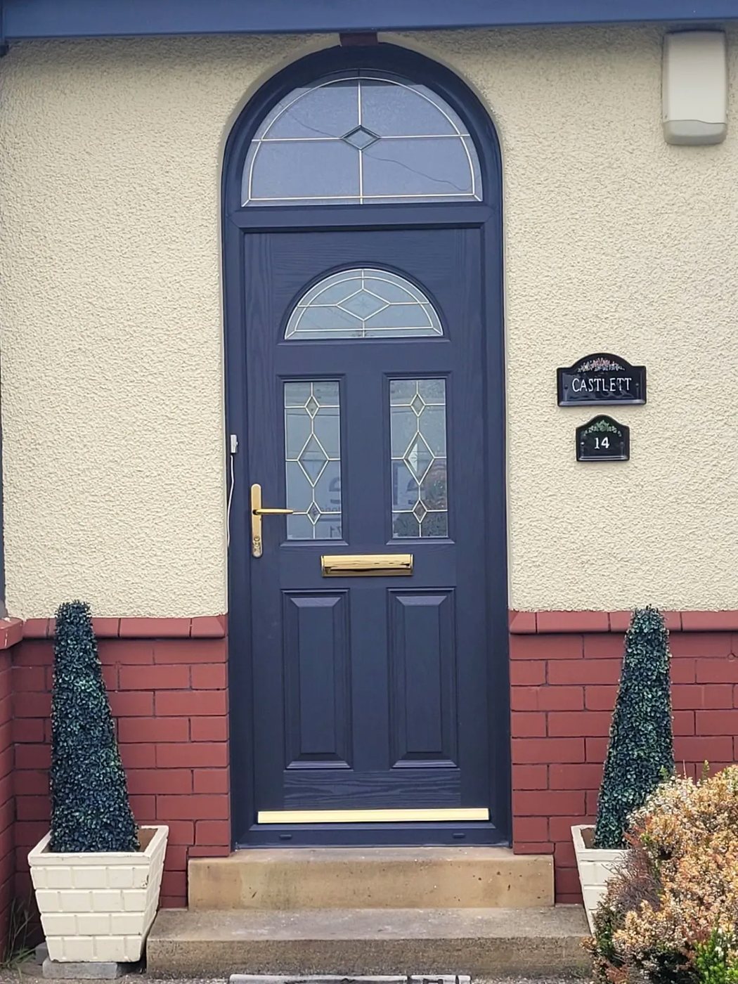 Anthracite grey composite front door with arched glass fanlight, fitted by GBD