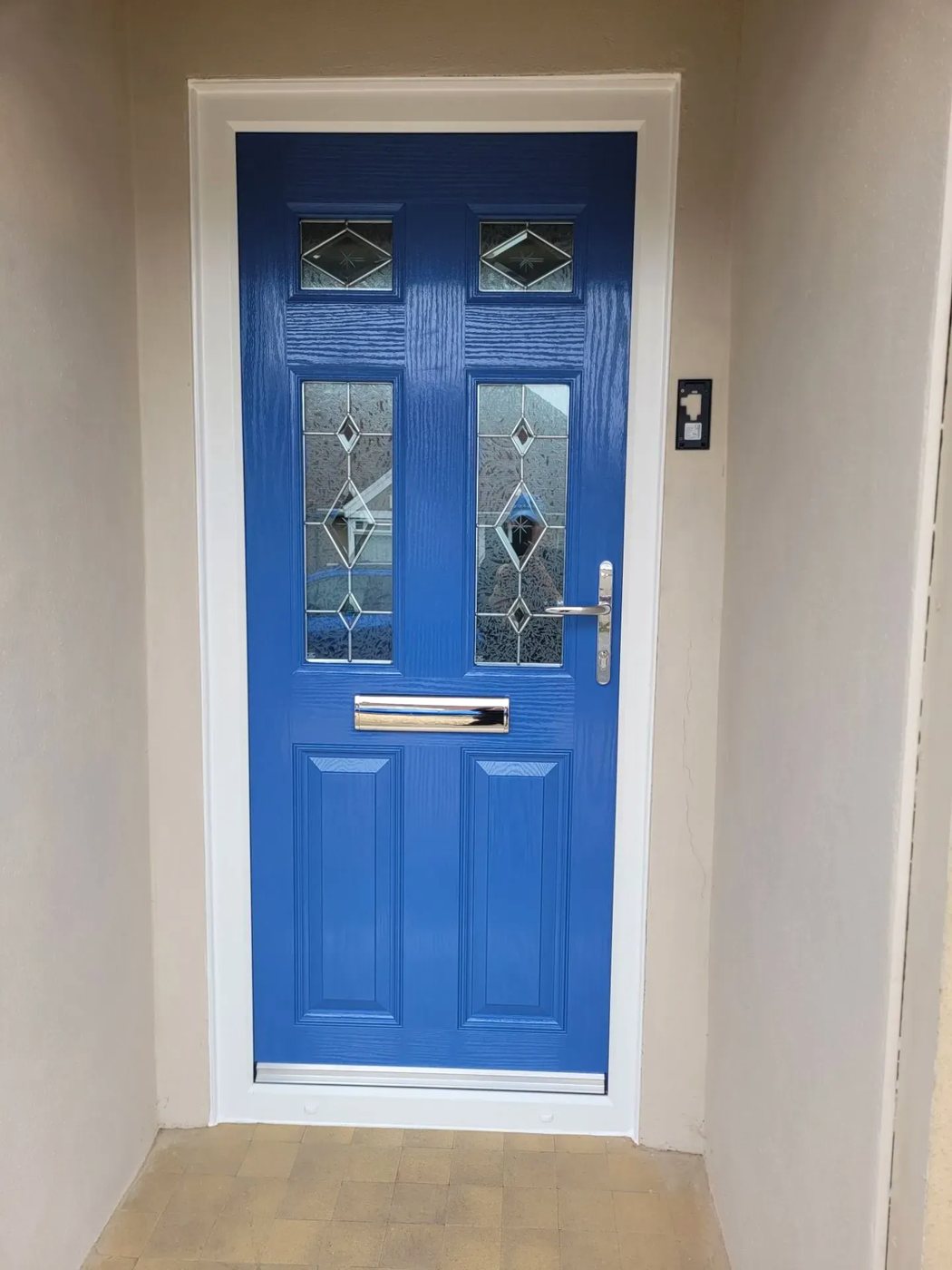 Blue composite front door with leaded diamond glass panels